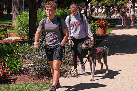 Students walking with a service dog. Links to Gifts by Will Students walking with a service dog. Links to Gifts by Will